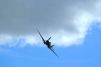 Low angle view of airplane flying against sky