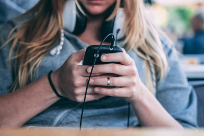 Midsection of woman using mobile phone at home