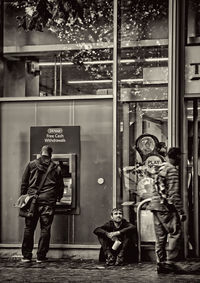 Man and woman standing by window in store