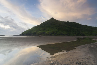 Scenic view of sea and mountains against sky