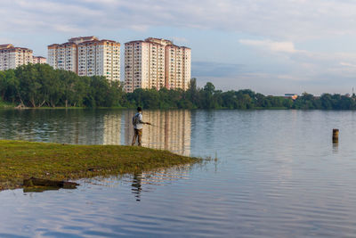 Man fishing near a blue lake, kundang.