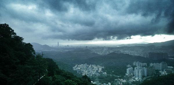 Buildings against cloudy sky