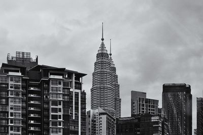 Low angle view of buildings against cloudy sky