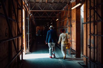 Rear view of people working at construction site