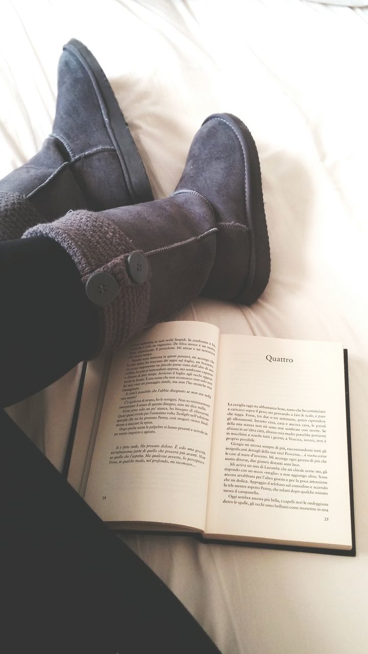 indoors, high angle view, communication, person, part of, shoe, book, close-up, low section, personal perspective, lifestyles, paper, unrecognizable person, footwear, text, bed