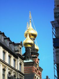 Low angle view of cathedral in city against clear blue sky