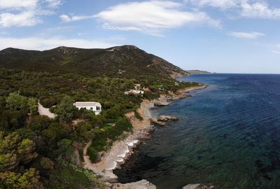 Scenic view of sea and mountains against sky