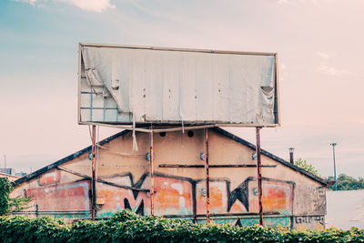 Metallic structure on field against sky