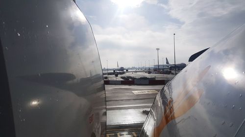 Close-up of airplane wing against sky