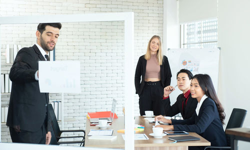 Cheerful business persons having discussion at office