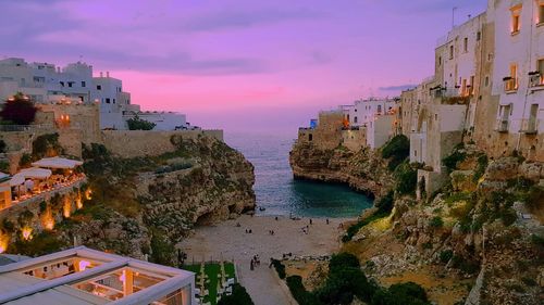 High angle view of buildings in city at sunset