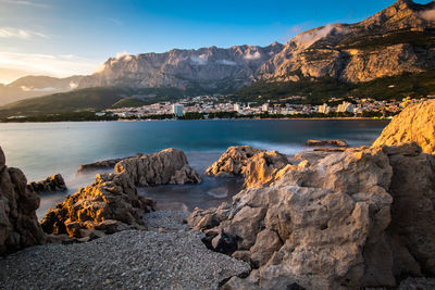 Scenic view of sea and mountains against sky