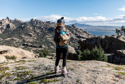 Rear view of woman standing on mountain