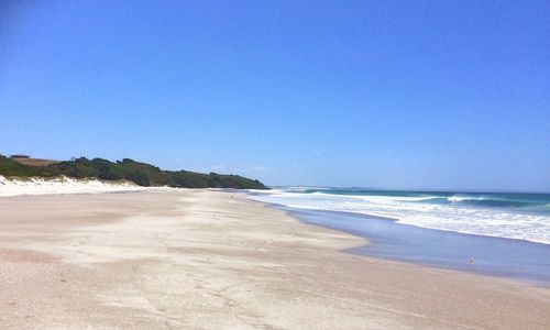 View of beach against blue sky