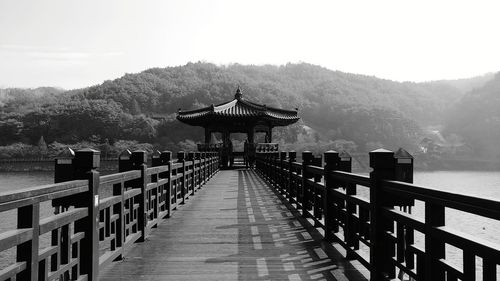 Pier over lake against sky