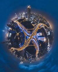 Digital composite image of illuminated buildings against sky