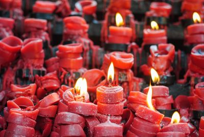 Full frame shot of lit candles in temple