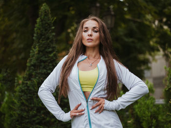 Mid adult woman standing with arms akimbo at park