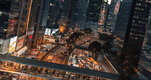 High angle view of illuminated street amidst buildings at night