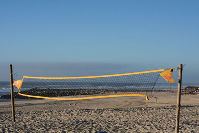 Scenic view of beach against clear blue sky