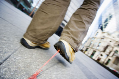 Low section of man walking on zebra crossing