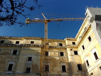 Low angle view of historical building against blue sky