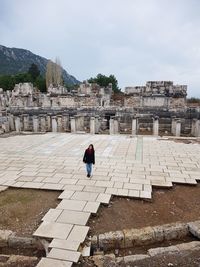 Young woman standing at old ruin