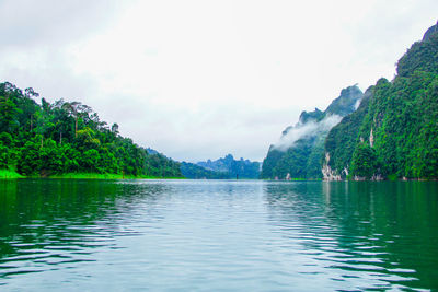 Scenic view of lake and mountains against sky