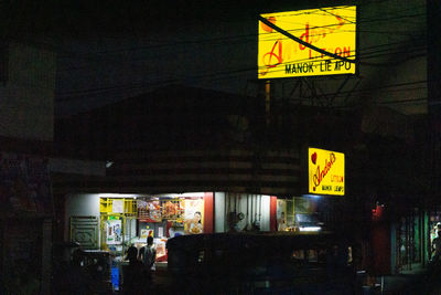 Information sign on illuminated city at night