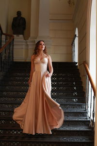 Young woman standing on staircase