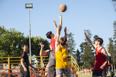 Teenager crew playing basketball