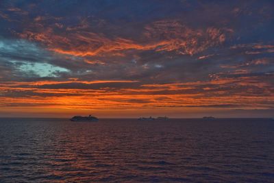 Scenic view of sea against orange sky