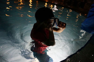 High angle view of woman photographing swimming pool