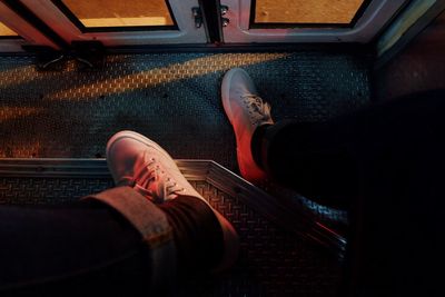 Low section of man sitting in train