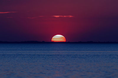 Scenic view of sea against romantic sky at sunset