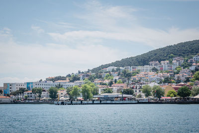 Town by sea against sky in city