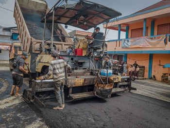 People working on street in city