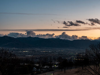 Scenic view of silhouette mountains against sky at sunset