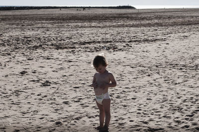 Full length of girl standing on beach