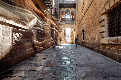 Narrow alley amidst buildings in city