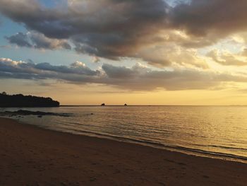 Scenic view of beach against sky during sunset