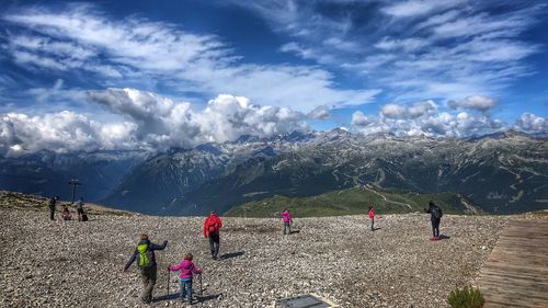 People on land against mountains