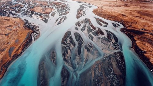 High angle view of water flowing on landscape