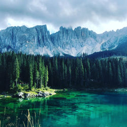 Scenic view of lake by mountains against sky