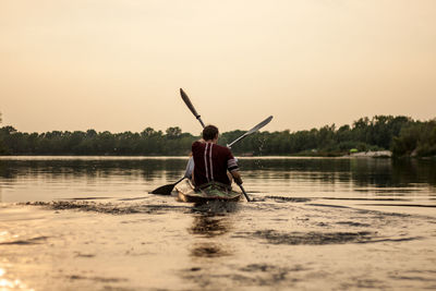 Rear view of man looking at lake