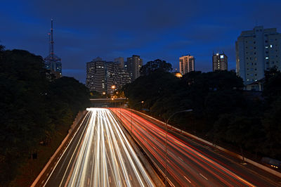 Light trails on road in city at night