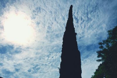Low angle view of silhouette trees against sky
