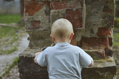 Rear view of boy playing outdoors