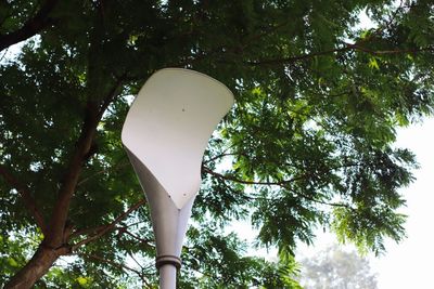 Low angle view of street light against tree