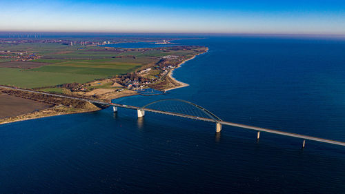 High angle view of sea and city against sky